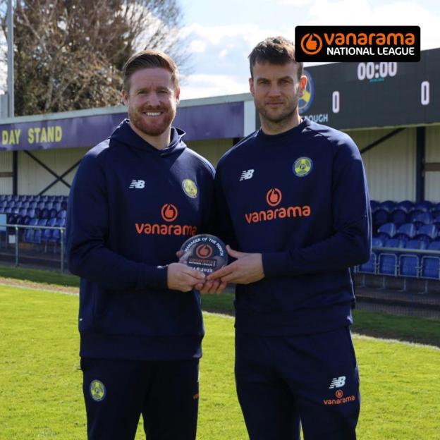Michael Gash and Luke Steele holding an award.