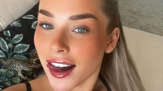 Glam footballer Madelene Wright cheekily sticks out tongue in busty snap as she shows fans inside new home