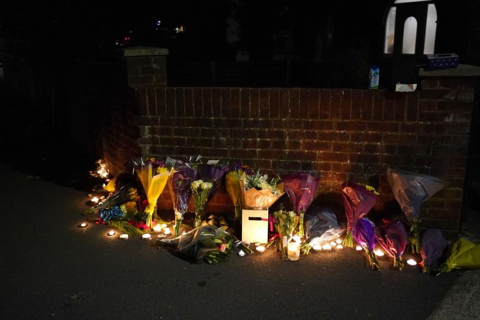 Flowers and candles placed near Midhurst Gardens in Uxbridge after a fatal stabbing.