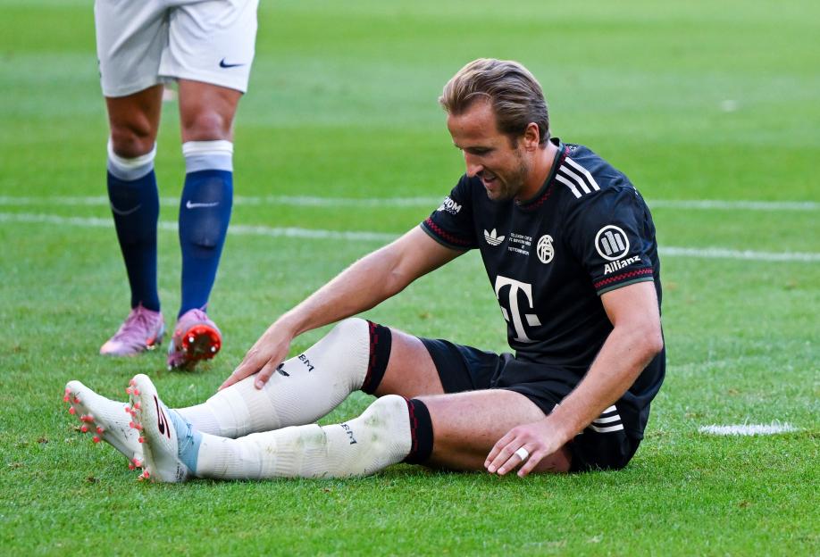 Harry Kane sitting on the field after missing a penalty kick.