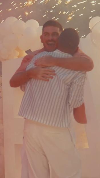 Adam Frisby and Jamie Corbett embracing.
