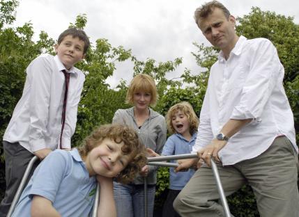 Photo of the cast of Outnumbered: Hugh Dennis, Claire Skinner, and their three child actors.