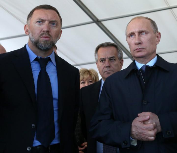 Vladimir Putin and two other men in suits.