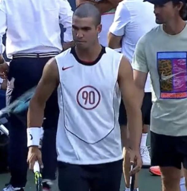Tennis player carrying a racket.