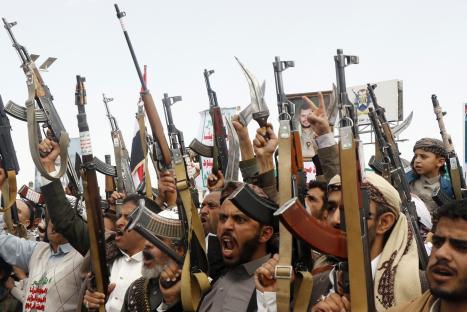 Houthi supporters in Sana'a, Yemen, brandishing weapons at a demonstration.