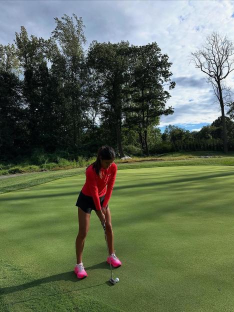 Woman putting on a golf green.
