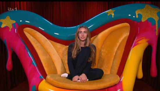 Ella Rae Wise sitting on a brightly colored chair, nominating contestants.