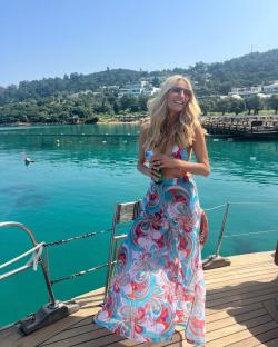 Tess Daly on a boat in Turkey wearing a patterned beach cover-up.