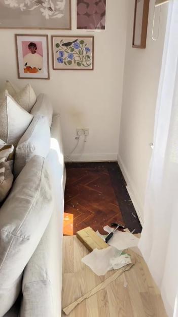 Woman removing floorboards in her apartment.