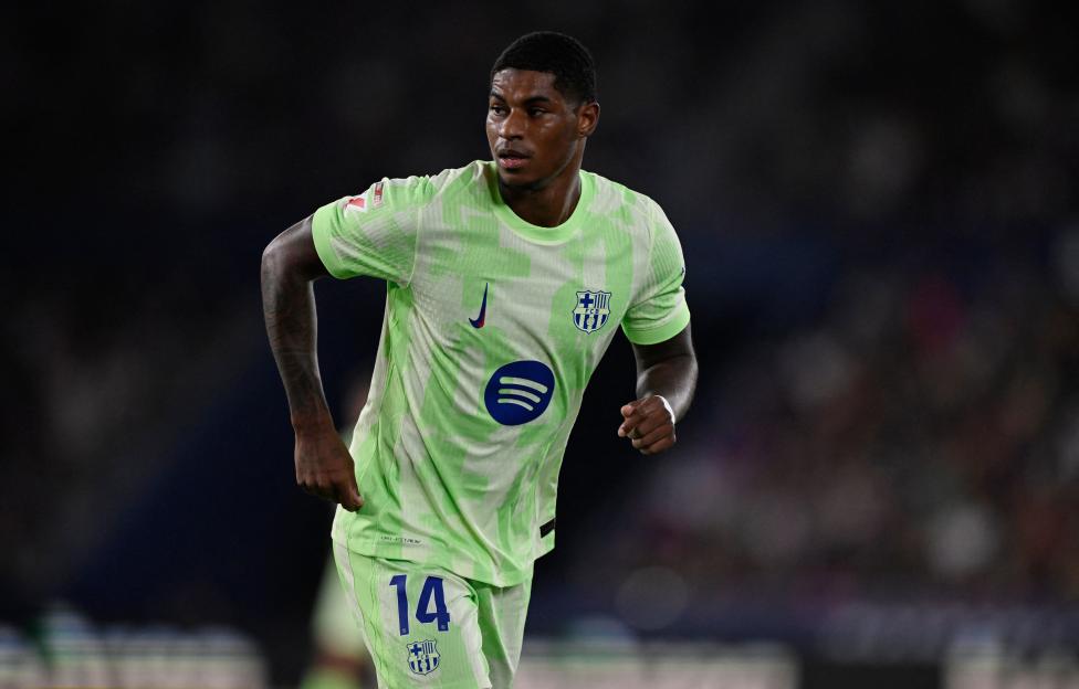 Marcus Rashford of FC Barcelona in a lime green jersey.