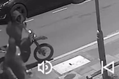 CCTV image of two men on an electric motorbike.