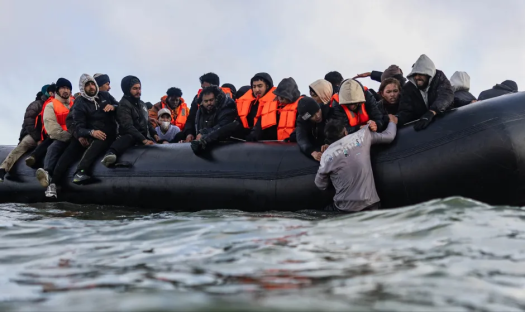 Fury as bungling Cabinet Minister claims most small boat migrants are women and children – despite majority being men