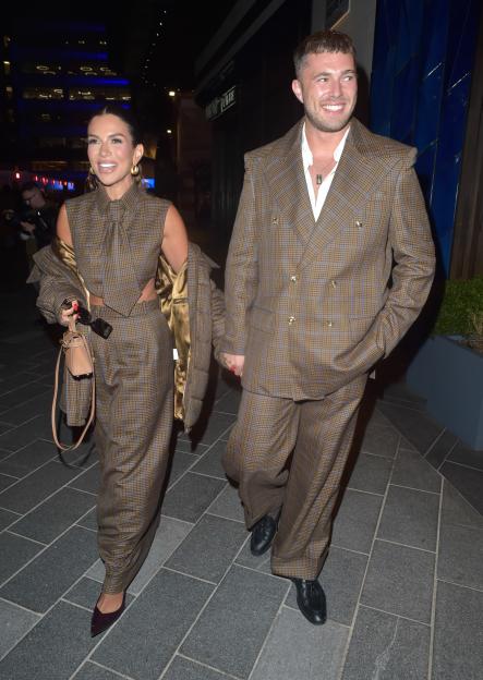 Ashley Roberts and AJ Pritchard holding hands and walking.