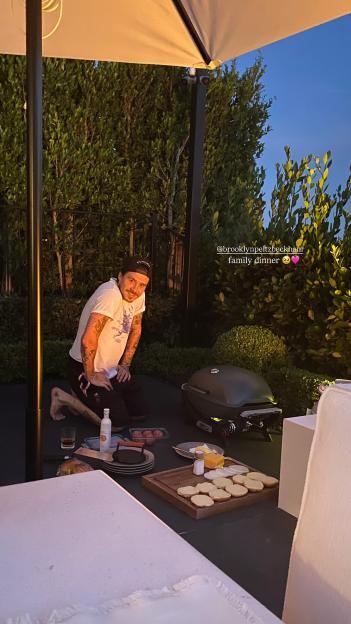 Brooklyn Beckham at an outdoor family dinner.
