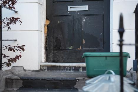 Fire-damaged front door of a property.