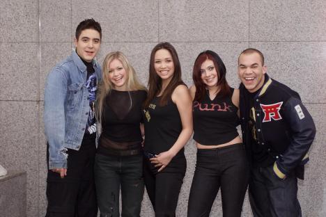 Pop group posing for a photo.