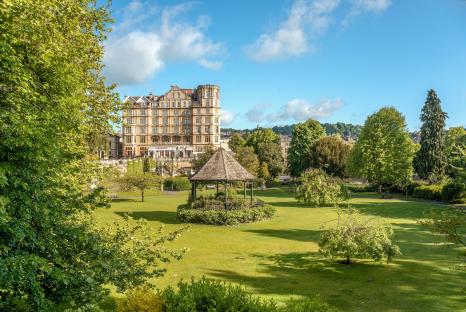 Parade Gardens in Bath, England, with a gazebo and a large building in the background.