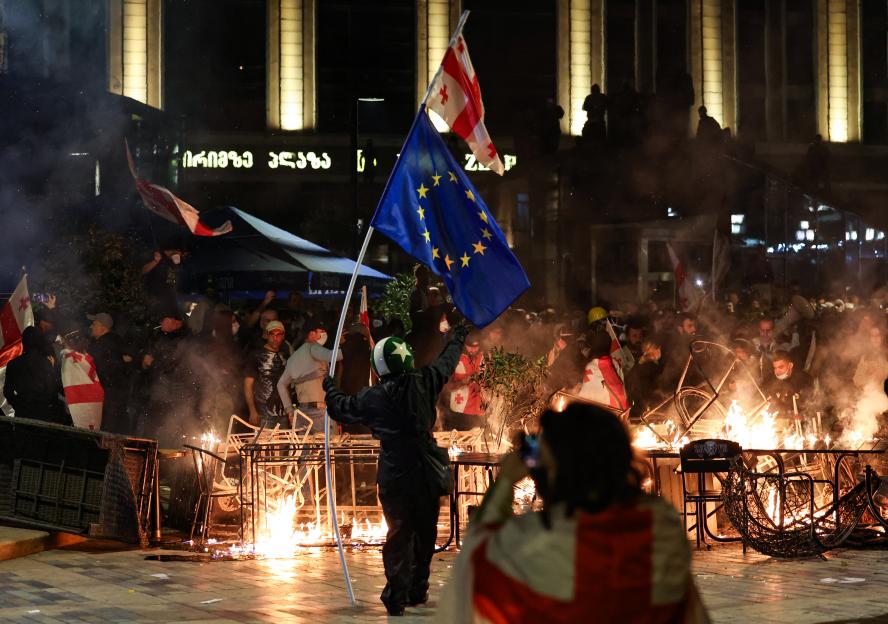Protesters burning barricades and clashing with police in central Tbilisi.