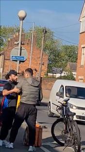 Two delivery drivers arguing in the street.
