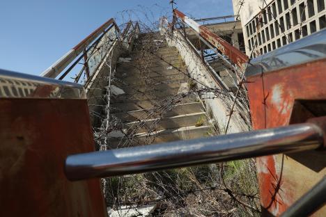 A stairway covered in barbed wire leads to the former visitor's restaurant and terrace