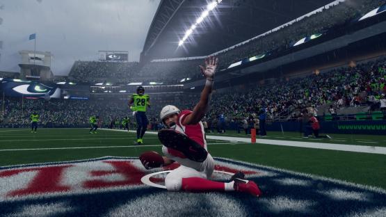 American football player making a touchdown in the rain.