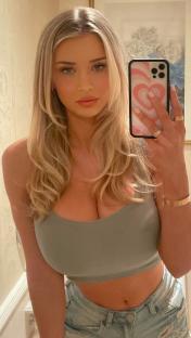 a woman taking a picture of herself in a mirror