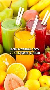 Three glasses of juice surrounded by fruit.