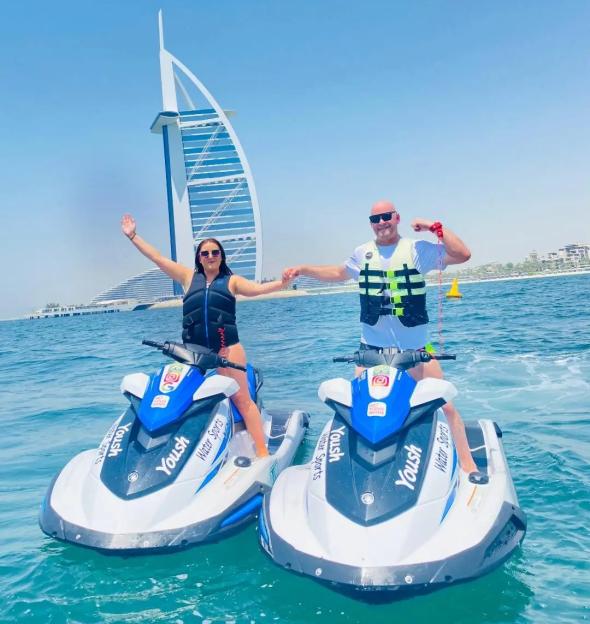 John Mitchell and Abi McMahon on jet skis in front of the Burj Al Arab in Dubai.