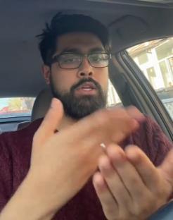 Man in car demonstrating a hand test.