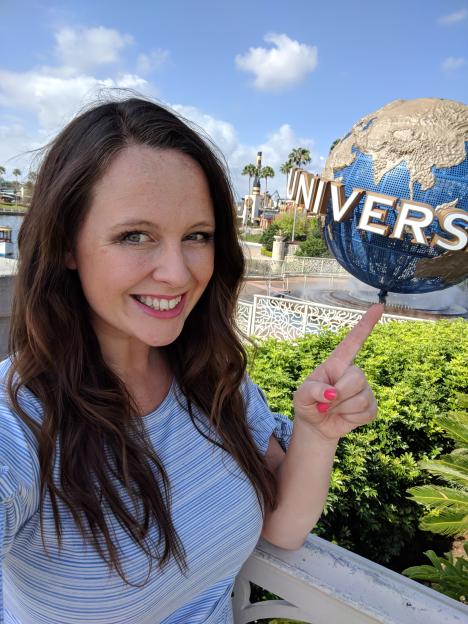 Woman pointing at Universal globe.