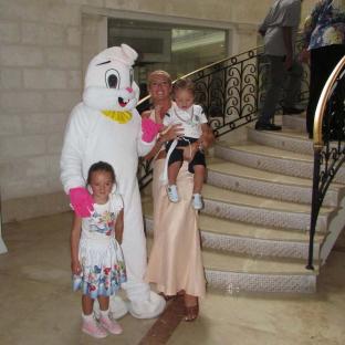 Woman with two children posing with an Easter Bunny.