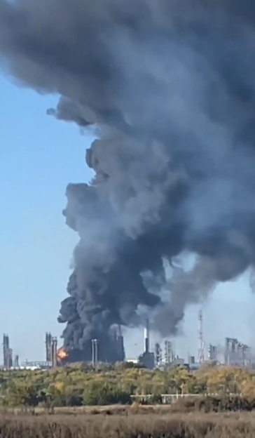 Thick black smoke rising from an industrial facility.