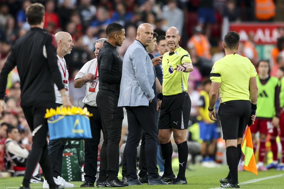 Referee Anthony Taylor speaking with Liverpool and AFC Bournemouth managers.
