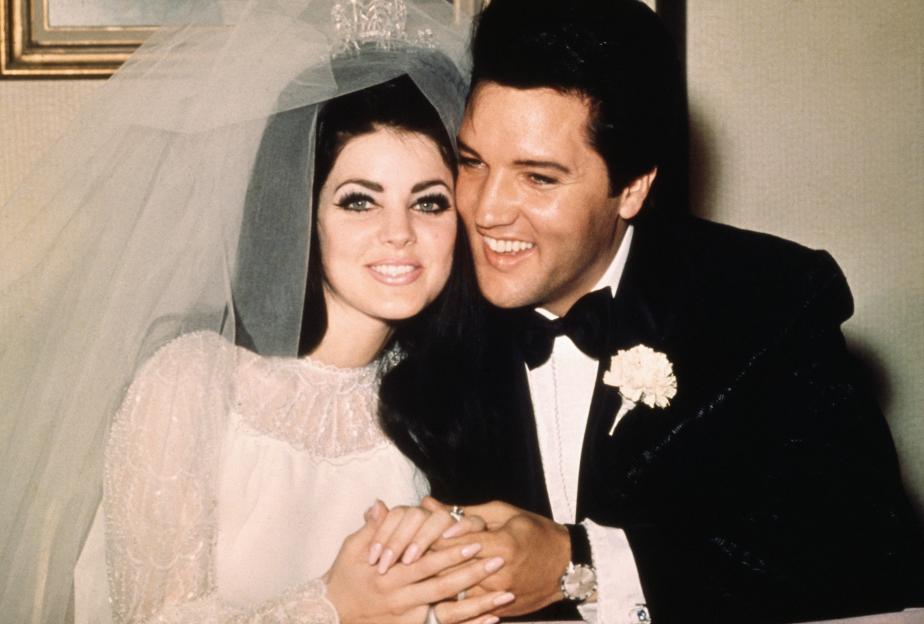 Elvis Presley and Priscilla Beaulieu posing for a wedding photo.