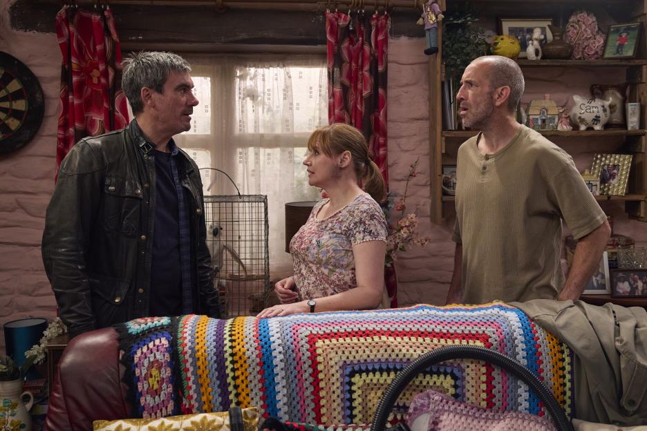 Still image from Emmerdale: Cain, Sam, and another character in a tense discussion.