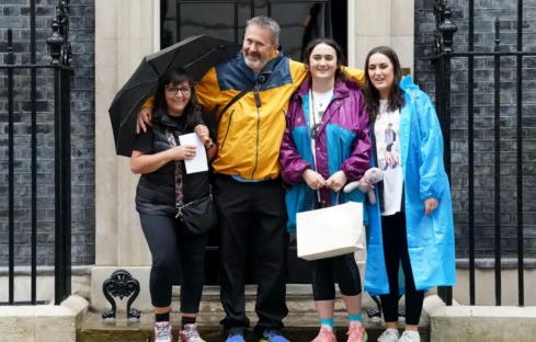 Family outside 10 Downing Street after a 200-mile walk to demand new terror laws.