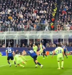 Soccer players tackling during a game.