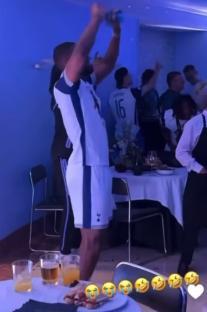 A Tottenham Hotspur player celebrates in a dressing room.