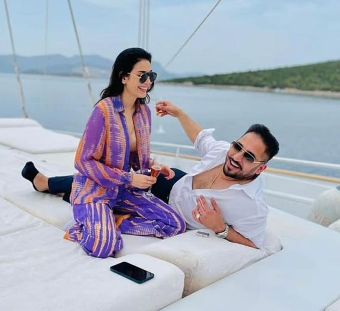 Salman Iftikhar and a woman relaxing on a yacht.
