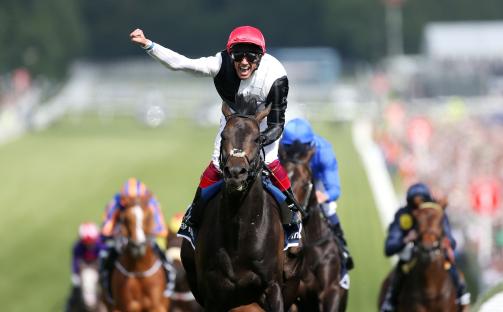 Frankie Dettori celebrating a horse race victory.