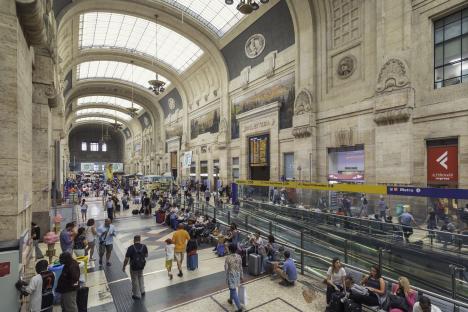 Crowded interior of Milano Centrale train station in Milan, Italy.