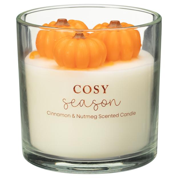 Cinnamon & nutmeg scented candle with pumpkin decorations.
