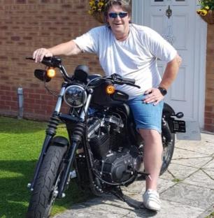 Man sitting on a motorcycle.