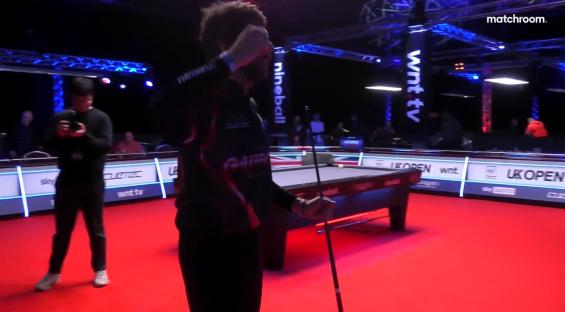 A pool player celebrates after a shot.