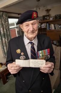 A 99-year-old World War II veteran holds a page from his secret diary.