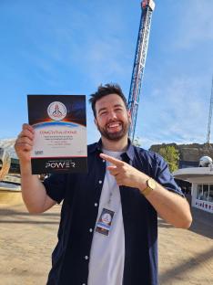 Man holding certificate for riding Blackpool's Launch Pad ride.