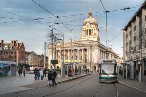 Nottingham Council House with tram and pedestrians.