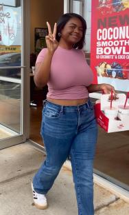 Woman leaving Smoothie King with smoothies.