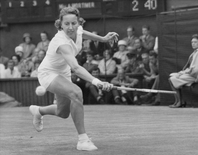Angela Mortimer playing tennis at Wimbledon.
