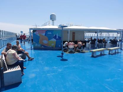 Passengers relaxing on the deck of a ferry from Portsmouth to Bilbao.